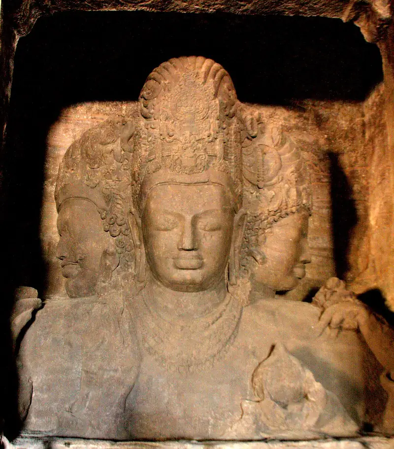 The colossal three-faced Trimurti sculpture inside the Elephanta Caves near Mumbai