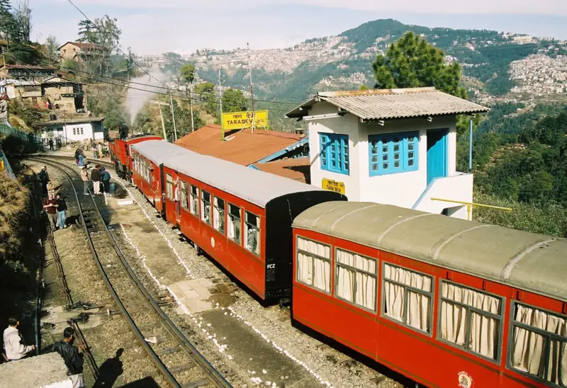 The narrow-gauge Kalka–Shimla toy train winding through forested hills