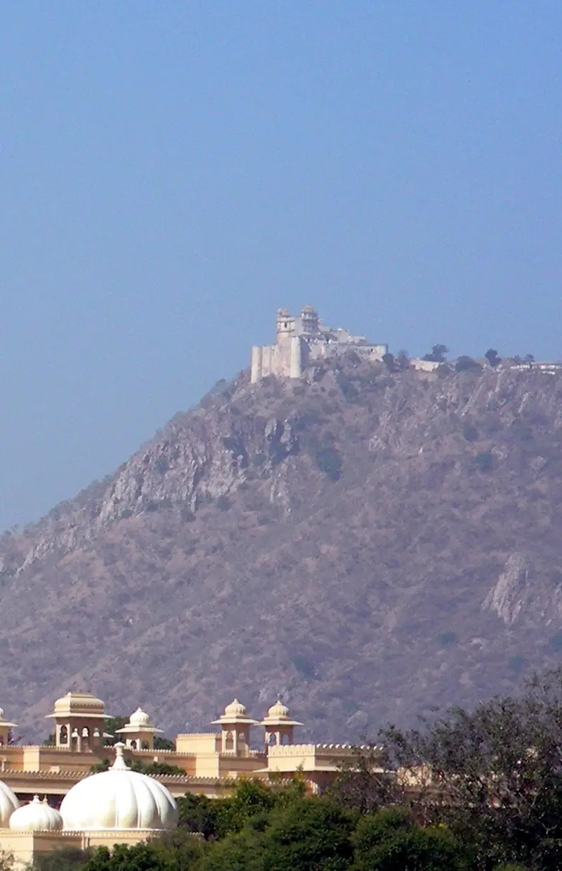 Sajjangarh Monsoon Palace crowning a hilltop above Udaipur at sunset