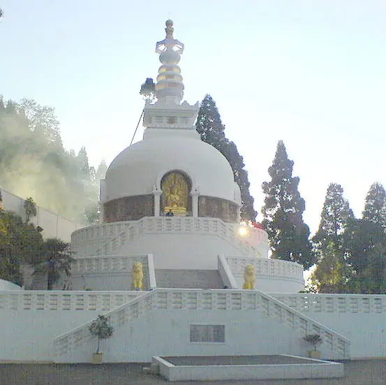 The white domed Peace Pagoda set against forested hills, Darjeeling