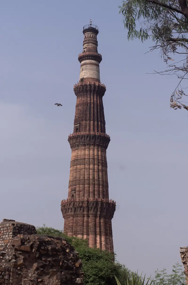The 73-metre Qutub Minar tower rising above its ruins, Delhi